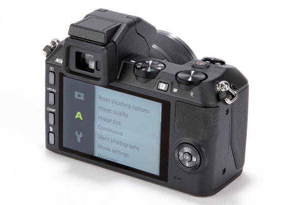 Nikon 1 V2 camera displaying menu settings on LCD screen.