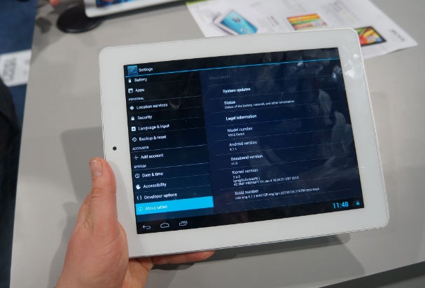 Hand holding Archos 97 Platinum tablet displaying settings menu.
