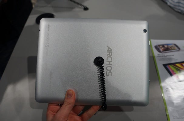 Hand holding Archos 97 Platinum tablet showing its back cover.Hand holding Archos 97 Platinum tablet displaying a game