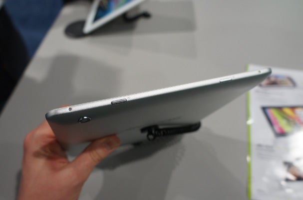 Side view of Archos 97 Platinum tablet showing portsHand holding Archos 97 Platinum tablet showcasing ports and buttons.