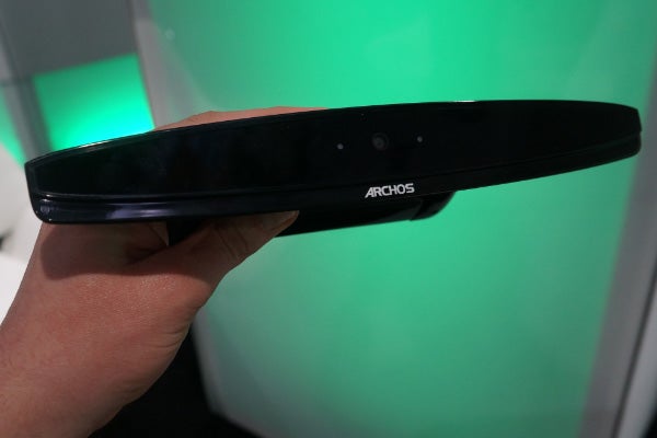 Hand holding Archos TV Connect controller side view.