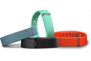 Fitbit Flex wristbands in black, teal, and red colors.