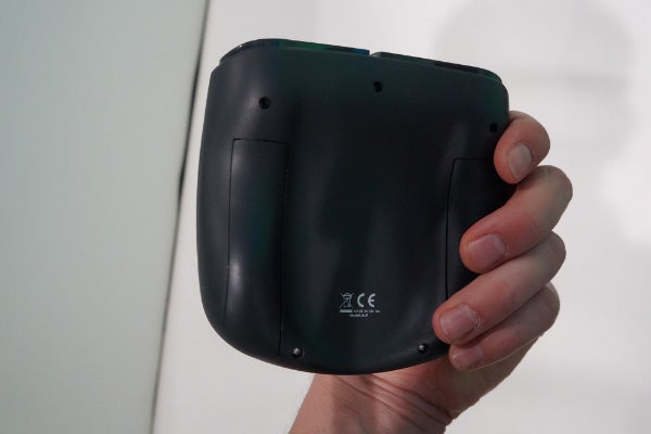 Hand holding the Archos TV Connect device from below.Archos TV Connect displaying a platform game on screen.