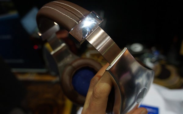 Hand holding Velodyne vTrue headphones, showing design details.