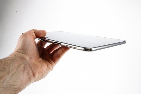 Hand holding a thin and light Dell XPS 10 tablet.