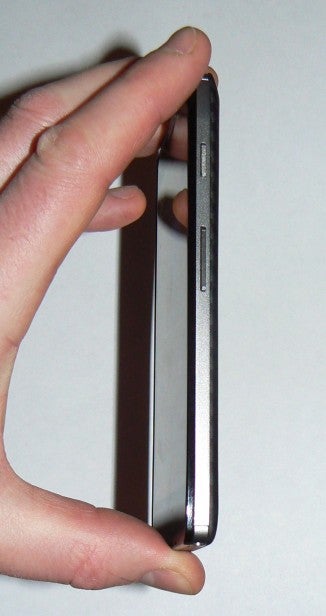 Hand holding Motorola Razr HD smartphone side view.