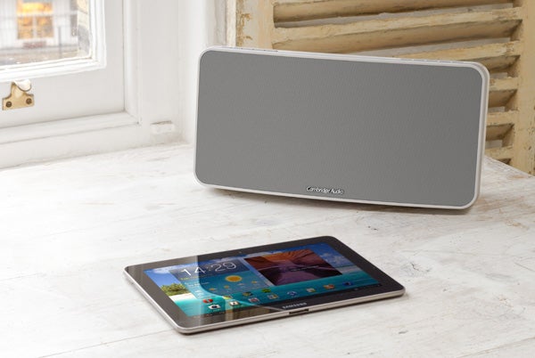 Cambridge Audio Minx Air 100 speaker beside a tablet on a windowsill.