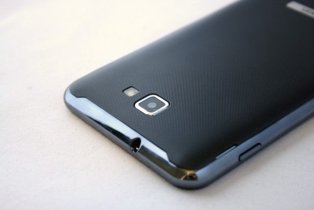 Close-up of a smartphone's camera and textured back cover.