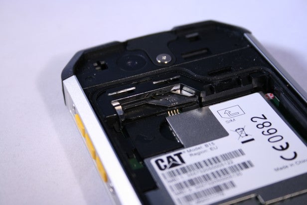 Smartphone with battery compartment open and SIM card visible.