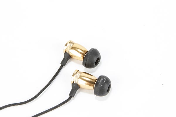 Gold-colored Motorheadphones Overkill earbuds on white background