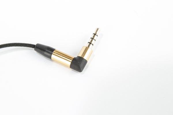 Gold and black headphone jack with braided cable.