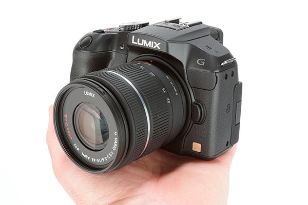 Panasonic Lumix G6 camera held in a person's hand.