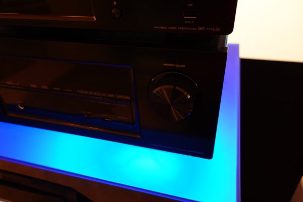 Denon AVR-X2000 receiver with illuminated blue stand.