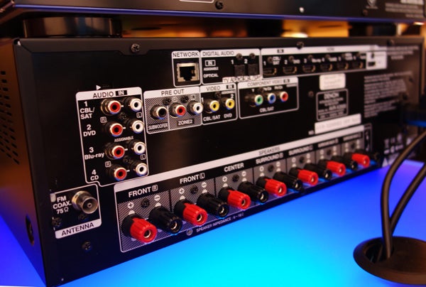 Rear view of Denon AVR-X2000 receiver's connection panel.Denon AVR-X2000 receiver with remote controlClose-up of Denon AVR-X2000 receiver's front panel controls.