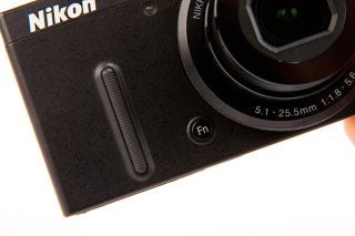 Close-up of Nikon Coolpix P330 camera showing lens and controls