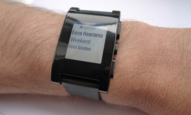 Smartwatch displaying notification on person's wrist.