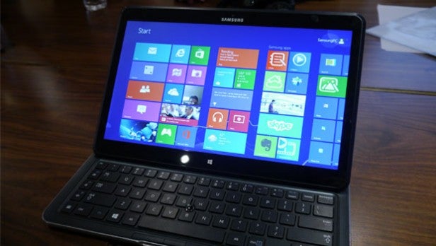 Samsung ATIV Q hybrid laptop with Windows Start screen.