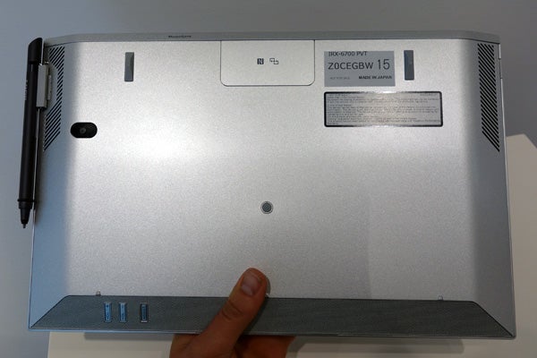 Sony Vaio Duo 13 laptop underside with stylus and product label.