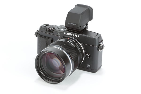 Olympus Pen E-P5 camera with lens and flash attached.