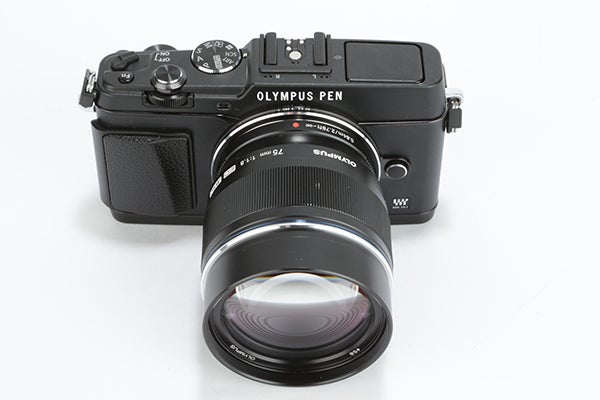 Olympus Pen E-P5 camera with attached lens on white background.