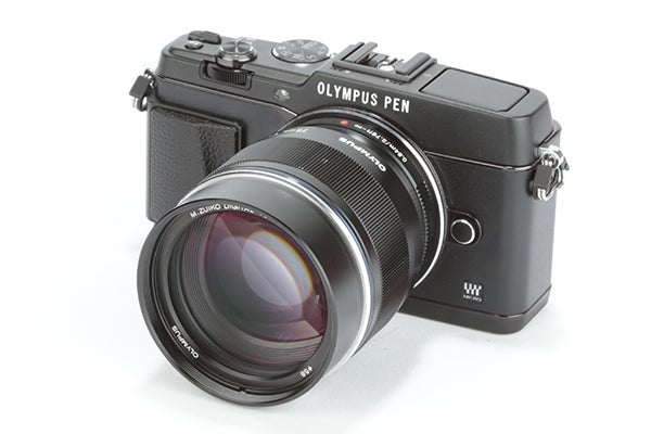 Olympus Pen E-P5 camera with attached lens.