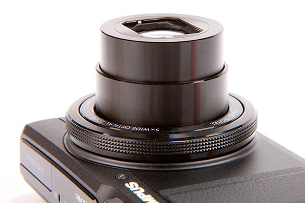 Close-up of Olympus XZ-10 camera lens and controls.