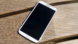 Samsung Galaxy Mega 6.3 smartphone on wooden surface.