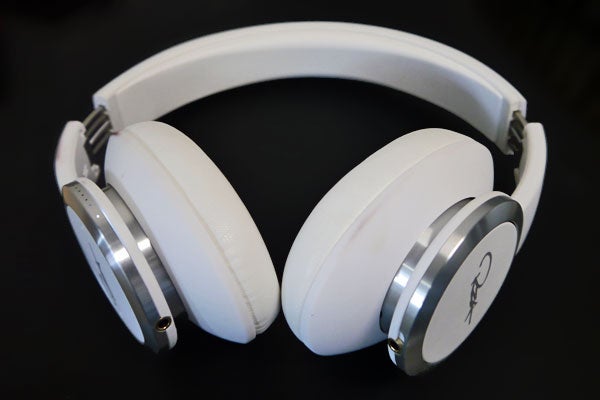 White WeSC Chambers by RZA headphones on black background.