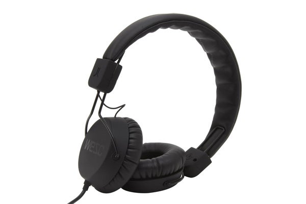 Black WeSC Piston headphones on a white background.