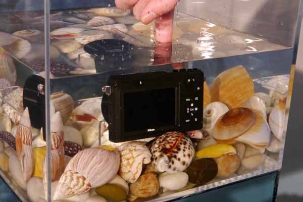 Nikon 1 AW1 camera underwater with seashells.