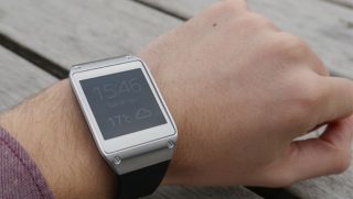 Samsung Galaxy Gear smartwatch on person's wrist.