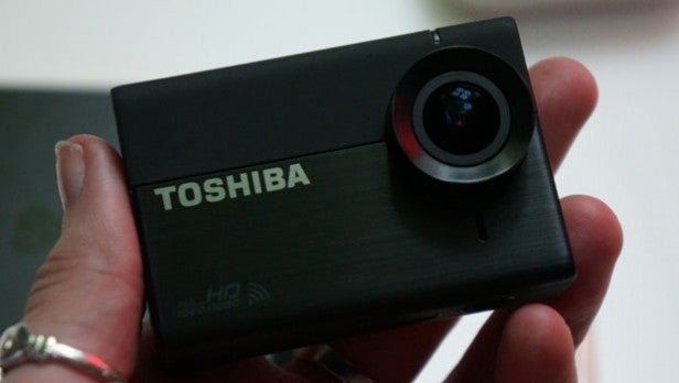 Toshiba Camileo X-Sports action camera held in handHand holding a Toshiba Camileo X-Sports action camera.