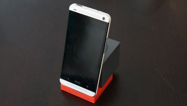 HTC smartphone docked on HTC BoomBass speaker.