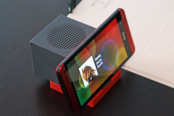 HTC BoomBass speaker paired with smartphone on desk.