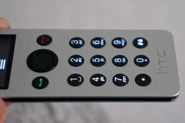 HTC Mini+ remote with illuminated buttons and screen.