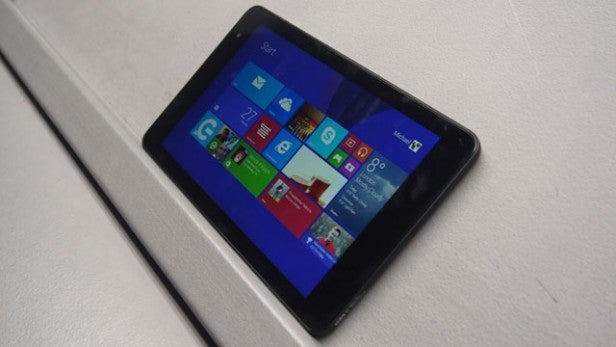 Tablet displaying Windows interface lying on white surface.