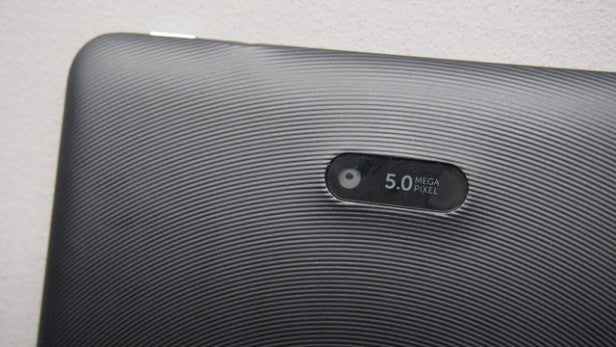 Close-up of 5.0-megapixel camera on textured device surface.