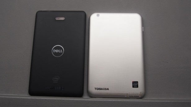 Two tablets back view, Dell and Toshiba, on gray surface.