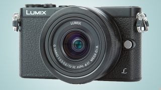 Panasonic Lumix DMC-GM1 camera on a light blue background.