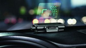 Garmin HUD projecting navigation data on car windshield at night.
