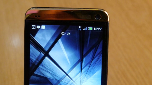 HTC One Gold edition smartphone displaying time and network status.