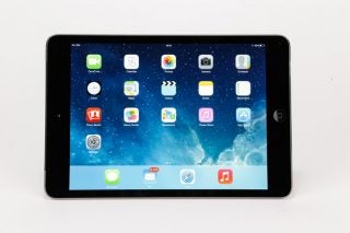 iPad mini 2 displaying home screen with app icons.