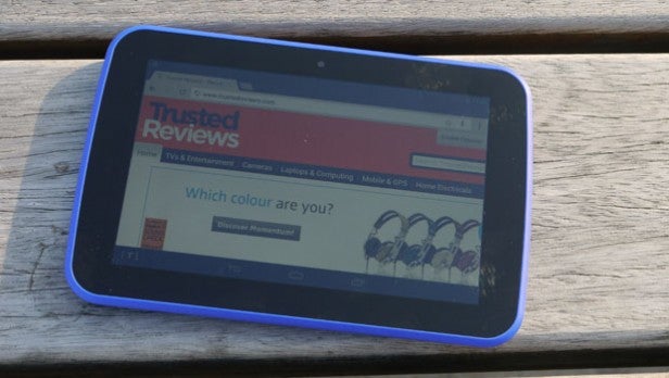 Tablet displaying Trusted Reviews webpage on wooden surface.