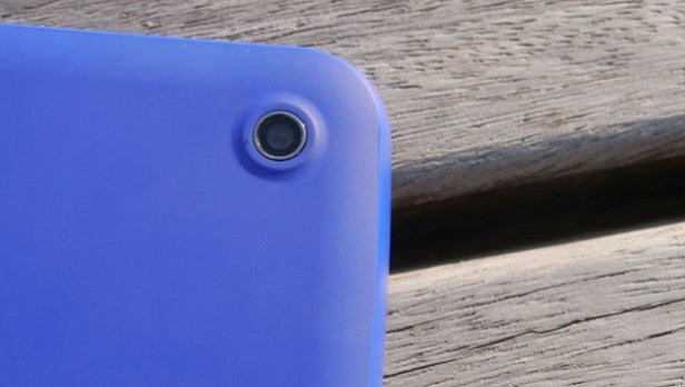 Close-up of blue device's camera on wooden background.