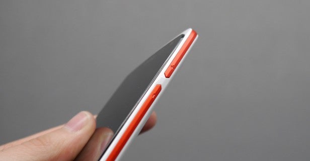 HTC Desire 500 smartphone held in hand showing side profile.