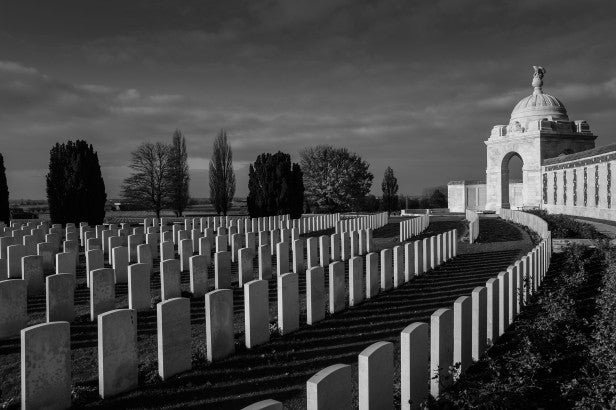High-contrast black and white photo of a military cemetery.