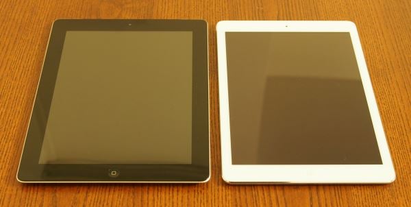 Black and white iPad Air tablets side by side on wood.