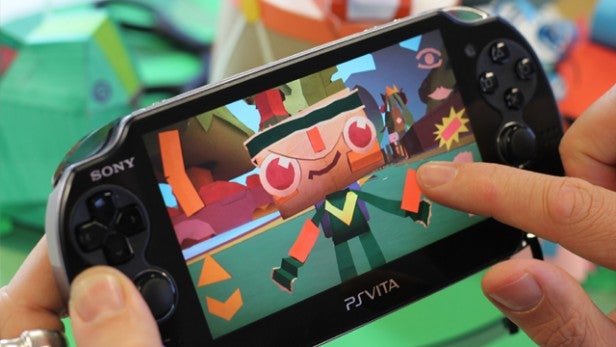 Hands playing Tearaway on a Sony PS Vita console.