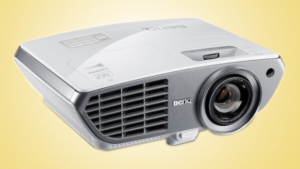 BenQ W1300 projector on a yellow background.