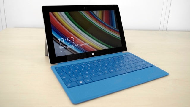 Microsoft Surface 2 with blue keyboard on a desk.